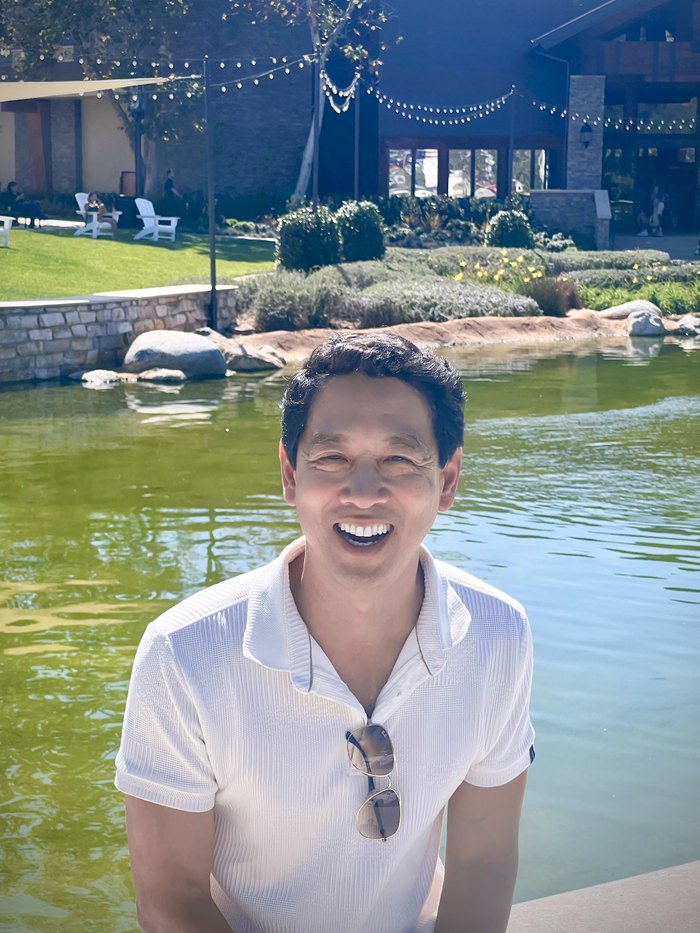 Dr. James Lin smiling outdoors by the water in Ventura County